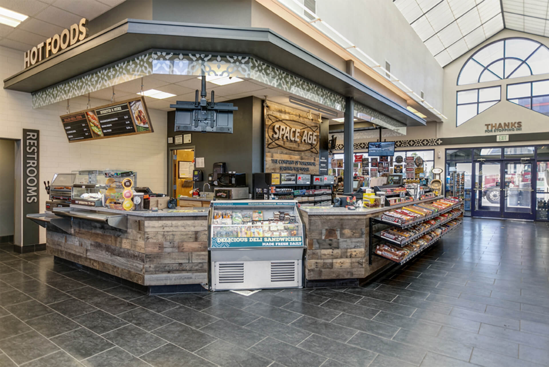 Space Age Fuel flagship — hot foods counter and c-store interior